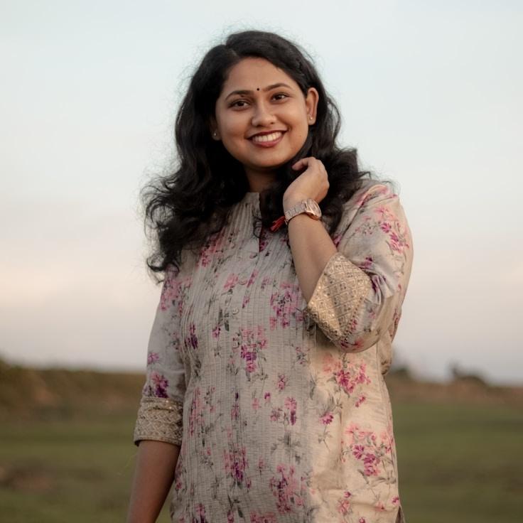 Kaveri Mehta, Lead Design Curator at WhisperCedarTrail, reviewing corporate floral arrangements